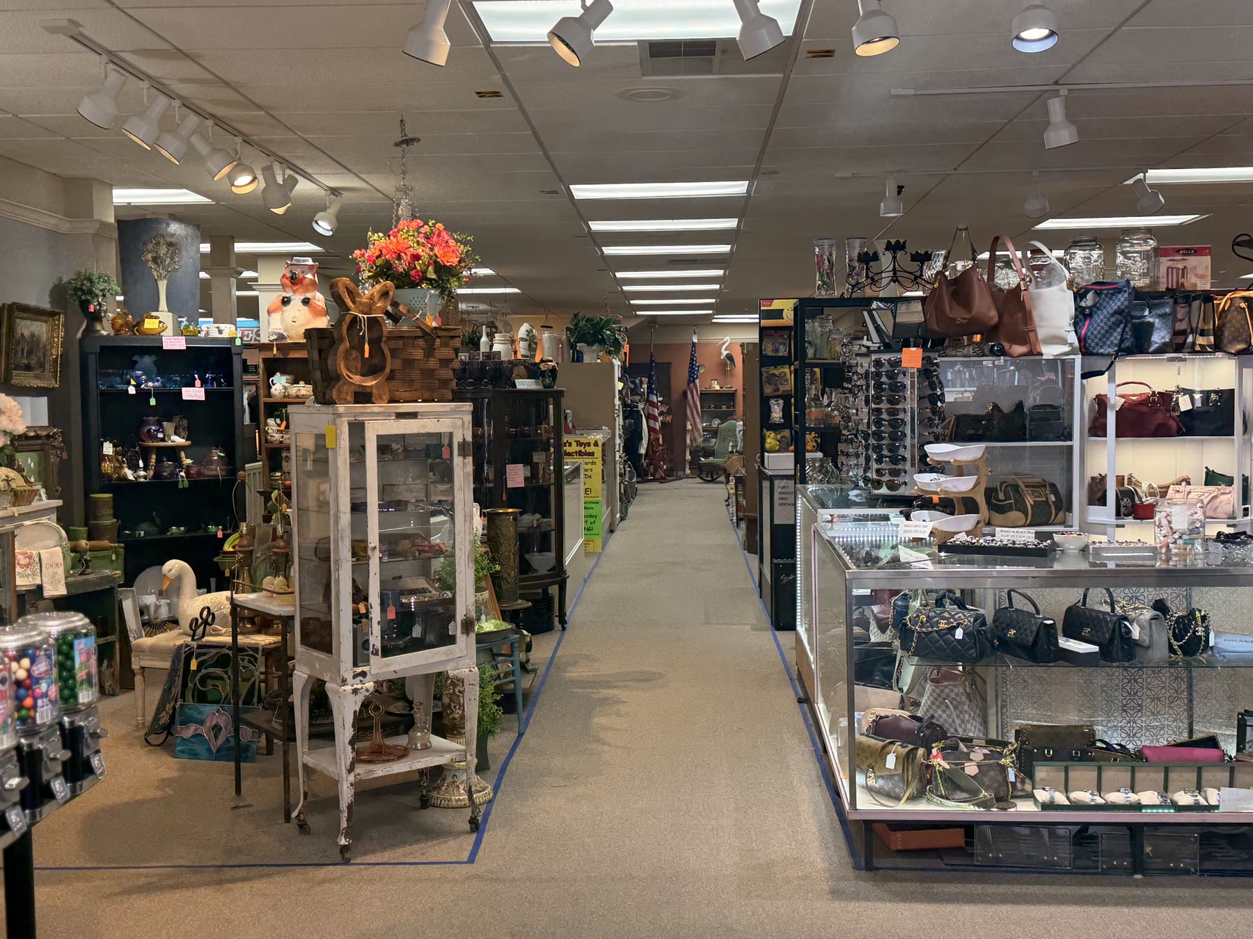 Long view down a marketplace aisle with track lighting