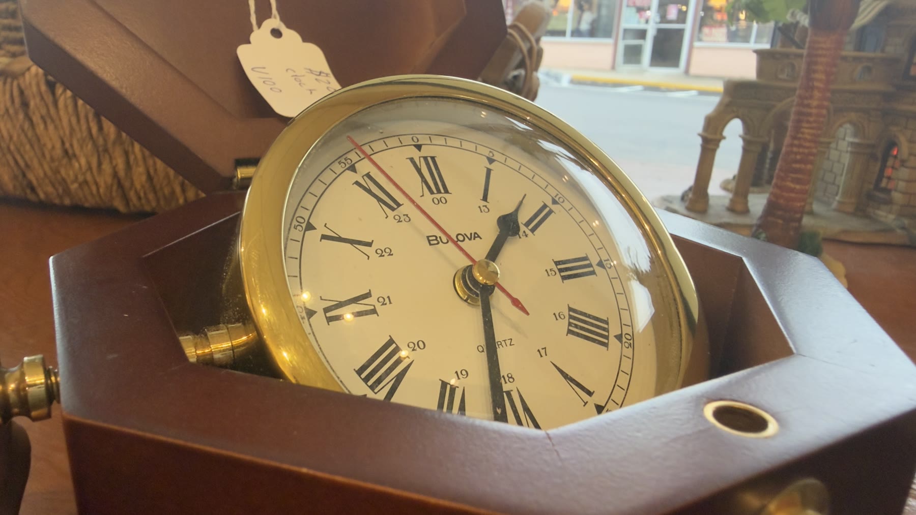 Vintage Bulova brass nautical clock with Hobson Avenue visible through the window