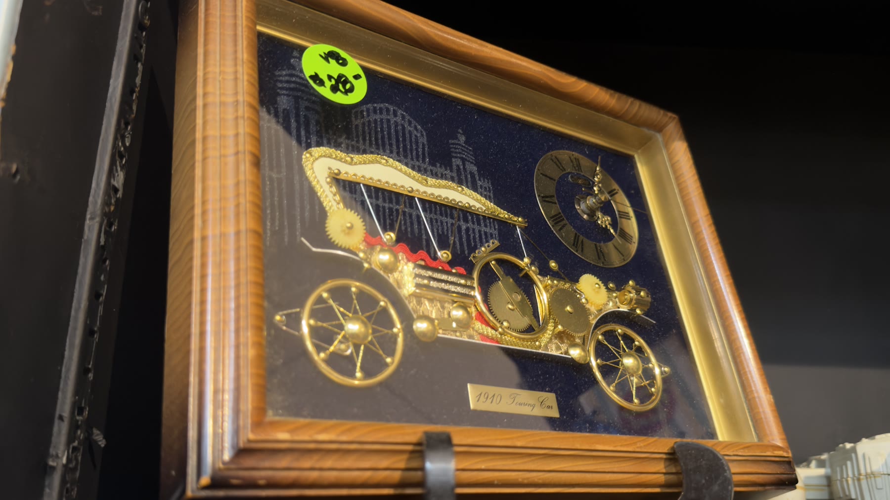 Framed clockwork art titled 1910 Touring Car made from gold gears and clock parts